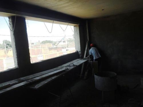 Working to finish men's dormitory